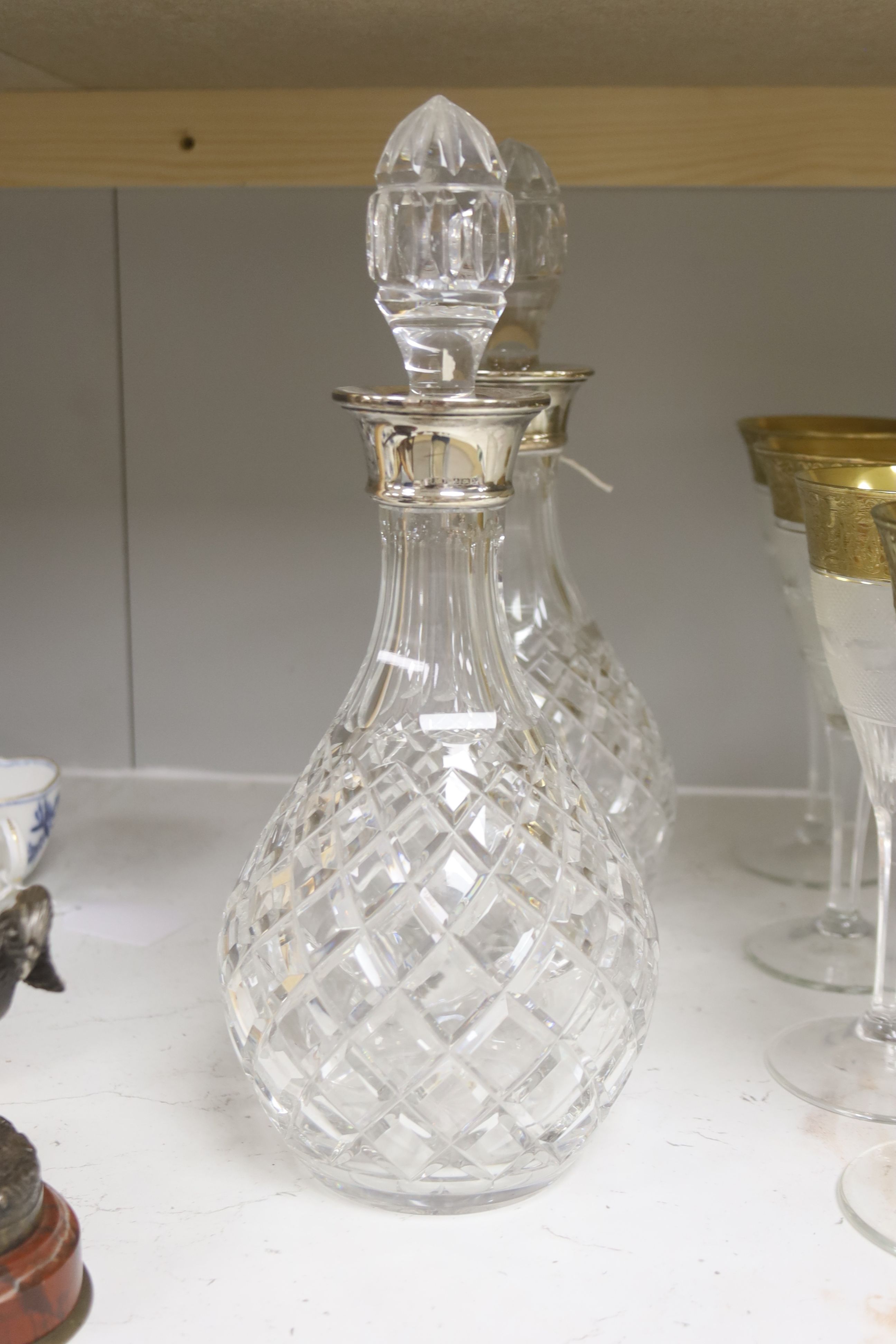 A pair of cut glass silver-mounted decanters and a quantity of cut crystal table glassware